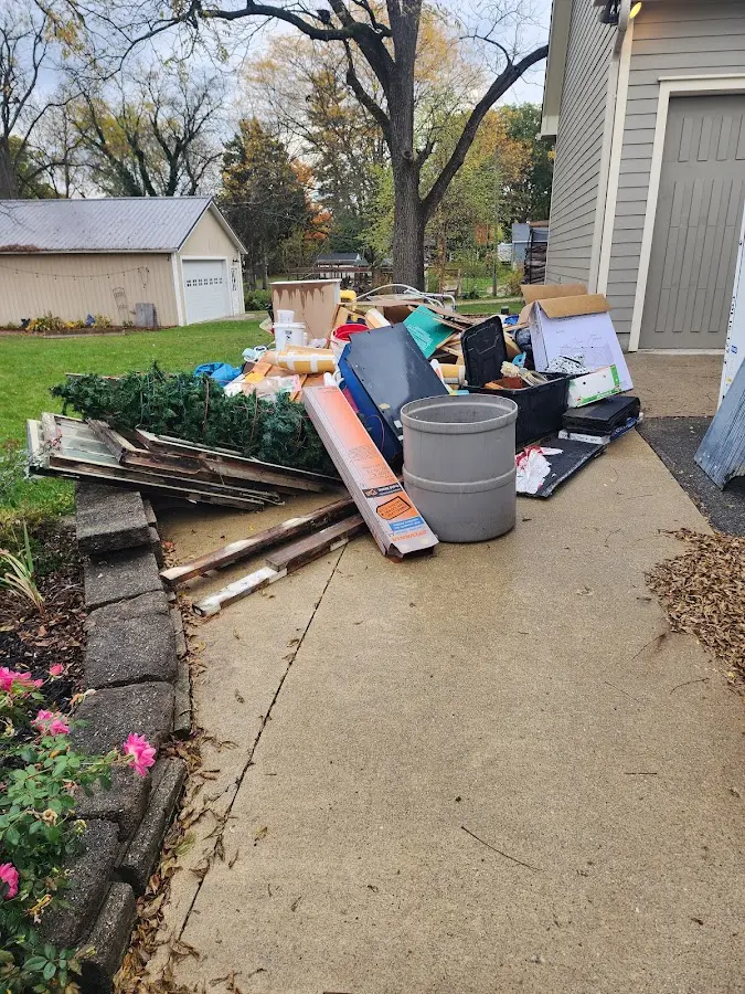 Dumpster being loaded with debris for Estate Cleanout Dumpster Rental in Sunset